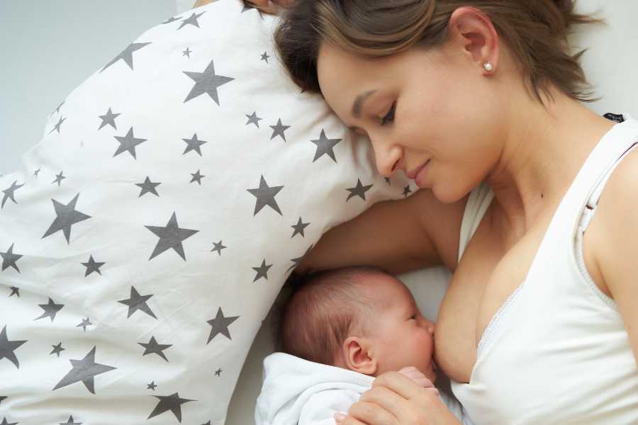 Mother is breastfeeding her newborn baby
